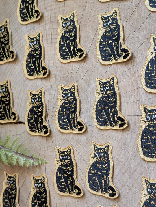 Iron-on patch | sitting black disappointed cat 2.9" x 2.2"